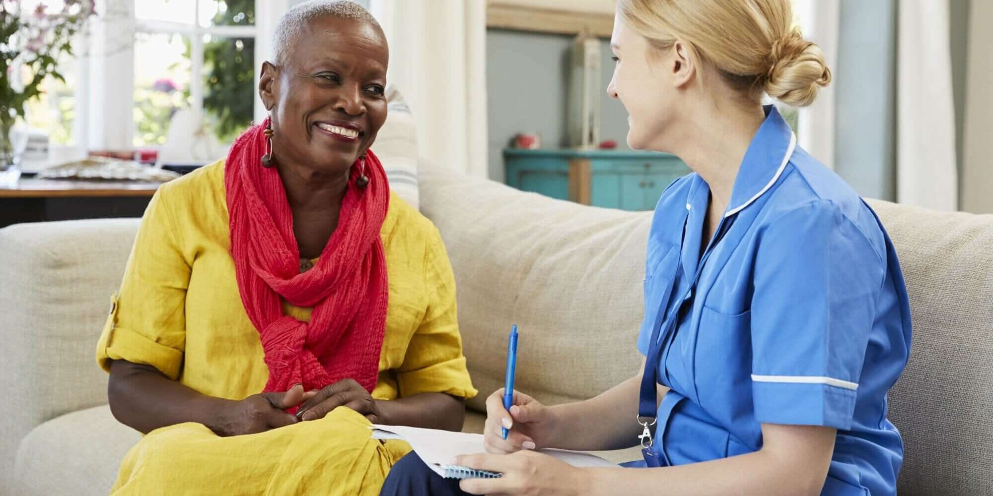 Nurse assisting an elderly woman
